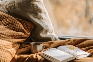 bed with book and tea